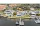 Aerial view of waterfront home with private dock, lush lawn, and sparkling pool at 200 Driftwood W Dr, Palm Harbor, FL 34683