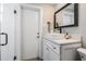 Bright bathroom featuring a white vanity, stylish square sink, and a glass-enclosed shower with sleek, dark hardware accents at 200 Driftwood W Dr, Palm Harbor, FL 34683