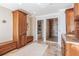 Bathroom featuring stone tile floors, cherry cabinets and countertops, and walk in shower at 200 Driftwood W Dr, Palm Harbor, FL 34683