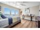Bedroom features hardwood floors, large window with water view, and contemporary decor at 200 Driftwood W Dr, Palm Harbor, FL 34683