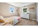 Bedroom features hardwood floors, pastel accents, and changing table at 200 Driftwood W Dr, Palm Harbor, FL 34683