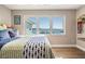 Bedroom featuring hardwood floors, large windows with water views, and contemporary decor at 200 Driftwood W Dr, Palm Harbor, FL 34683
