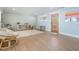 Bright bonus room offers ample space for play and relaxation, featuring a charming wooden door and ample lighting at 200 Driftwood W Dr, Palm Harbor, FL 34683