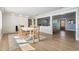 Bright dining area with a white table, wicker chairs, and wood flooring at 200 Driftwood W Dr, Palm Harbor, FL 34683