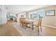 Open-concept dining area featuring water views, seamlessly connected to a modern kitchen with a breakfast bar at 200 Driftwood W Dr, Palm Harbor, FL 34683