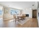 Bright dining room featuring a stylish dining table with seating, a fireplace, and water views at 200 Driftwood W Dr, Palm Harbor, FL 34683
