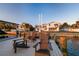 Waterfront home featuring a private dock with Adirondack chairs for enjoying scenic sunsets at 200 Driftwood W Dr, Palm Harbor, FL 34683