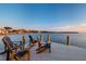 Adirondack chairs on a private dock, a perfect spot for sunset views at 200 Driftwood W Dr, Palm Harbor, FL 34683