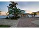Charming home featuring lush landscaping, brick driveway, and an attached garage at 200 Driftwood W Dr, Palm Harbor, FL 34683