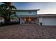 Inviting home with a brick driveway, covered porch, and well-manicured landscaping at 200 Driftwood W Dr, Palm Harbor, FL 34683