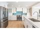 Kitchen featuring stainless steel appliances, modern cabinetry, and subway tile backsplash at 200 Driftwood W Dr, Palm Harbor, FL 34683