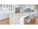 Modern kitchen with large island, quartz countertops, stainless appliances and seating at 200 Driftwood W Dr, Palm Harbor, FL 34683