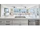 Bright, modern kitchen features granite countertops, stainless appliances, and beautiful water views at 200 Driftwood W Dr, Palm Harbor, FL 34683