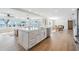 Open concept kitchen with island seating and panoramic water views from adjacent living area at 200 Driftwood W Dr, Palm Harbor, FL 34683