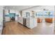 Open-concept kitchen with stainless steel appliances, large island, and views of the water at 200 Driftwood W Dr, Palm Harbor, FL 34683