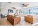 Living area with panoramic water views, comfortable seating, and ceiling fans at 200 Driftwood W Dr, Palm Harbor, FL 34683