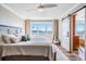 Bright main bedroom features large windows with water views and light hardwood flooring at 200 Driftwood W Dr, Palm Harbor, FL 34683