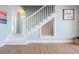 Charming staircase with custom under-stair storage and natural wood floors at 200 Driftwood W Dr, Palm Harbor, FL 34683