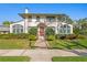 Charming two-story home with a well-manicured lawn and a vibrant red front door at 201 72Nd N St, St Petersburg, FL 33710