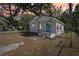Charming home featuring an inviting front porch, well-maintained landscaping, and delightful curb appeal on a sunny day at 2111 E Ellicott St, Tampa, FL 33610