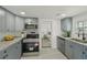 Well-equipped kitchen with gray cabinetry, stainless steel appliances, and modern fixtures at 2111 E Ellicott St, Tampa, FL 33610