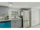 Modern kitchen featuring gray cabinets, stainless steel appliances, and stylish granite countertops at 2111 E Ellicott St, Tampa, FL 33610