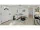 Bright living room featuring neutral furniture, modern decor, and a stylish area rug at 2111 E Ellicott St, Tampa, FL 33610