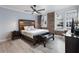Spacious bedroom features exposed brick, a ceiling fan, and hardwood floors at 215 Central Ave # 4H, St Petersburg, FL 33701