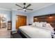 Bedroom with wood headboard features ensuite bathroom with closet space at 215 Central Ave # 4H, St Petersburg, FL 33701