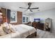 Bedroom featuring exposed brick, a ceiling fan, and a large mirror at 215 Central Ave # 4H, St Petersburg, FL 33701