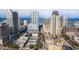 Expansive city view showcases high-rise buildings, busy streets, and construction sites against the backdrop of the ocean at 215 Central Ave # 4H, St Petersburg, FL 33701