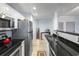 Kitchen featuring stainless steel appliances, granite countertops, modern fixtures, and hardwood floors at 215 Central Ave # 4H, St Petersburg, FL 33701
