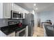 Kitchen featuring stainless steel appliances, granite countertops, and hardwood floors at 215 Central Ave # 4H, St Petersburg, FL 33701