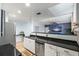 Spacious kitchen with black countertops, stainless steel appliances, open concept layout, and hardwood floors at 215 Central Ave # 4H, St Petersburg, FL 33701