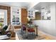 Living Room featuring an exposed brick wall, hardwood floors, modern decor, and an open kitchen view at 215 Central Ave # 4H, St Petersburg, FL 33701