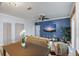 Cozy living room with ceiling fan, TV, and blue accent wall at 215 Central Ave # 4H, St Petersburg, FL 33701