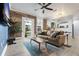 Spacious living room featuring exposed brick, hardwood floors, and a modern ceiling fan at 215 Central Ave # 4H, St Petersburg, FL 33701