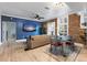 Living Room with a blue accent wall, hardwood floors, exposed brick, modern decor and lots of light at 215 Central Ave # 4H, St Petersburg, FL 33701