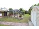 A screened pool and a storage shed with lush backyard featuring well-maintained brick pavers at 229 Tazewell Dr, Port Charlotte, FL 33954
