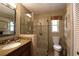 Clean bathroom featuring a single sink vanity, tiled shower with glass door, and updated fixtures at 229 Tazewell Dr, Port Charlotte, FL 33954