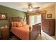 A bedroom featuring a ceiling fan, doorway to the outside, and matching wood furniture at 229 Tazewell Dr, Port Charlotte, FL 33954