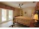 A lovely bedroom with a ceiling fan, double doors to the lanai, and neutral-toned walls at 229 Tazewell Dr, Port Charlotte, FL 33954