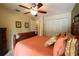 A bedroom featuring a ceiling fan, a closet, and decorative pillows at 229 Tazewell Dr, Port Charlotte, FL 33954