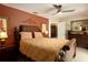 Well-decorated bedroom featuring a ceiling fan, neutral and rusty red walls, and elegant furnishings at 229 Tazewell Dr, Port Charlotte, FL 33954