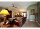 Spacious living room with tile flooring, ceiling fan, and an open floor plan leading to the dining area at 229 Tazewell Dr, Port Charlotte, FL 33954