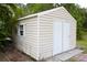 A bright outdoor shed with double doors, a small window, and neutral colored siding at 229 Tazewell Dr, Port Charlotte, FL 33954