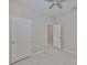 Open bedroom with ceiling fan, multiple doors, and plank-style flooring at 2807 W Granfield Ave, Plant City, FL 33563