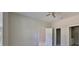 Spacious bedroom with ceiling fan, neutral paint, and two entry doors at 2807 W Granfield Ave, Plant City, FL 33563