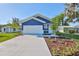 Beautiful blue single-Gathering home with a well-manicured lawn and landscaping at 2807 W Granfield Ave, Plant City, FL 33563