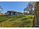 Exterior view of home features a well-maintained lawn and mature trees at 2807 W Granfield Ave, Plant City, FL 33563